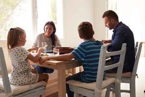 Mom enjoying eating with her family without fear of chronic illness flare