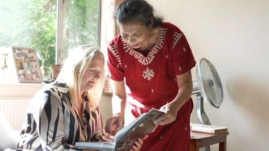 Women looking at album