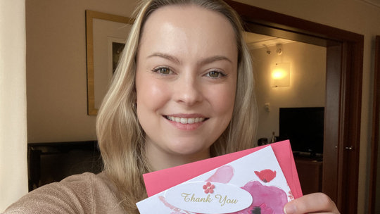 Jessica Payne holding thank you card