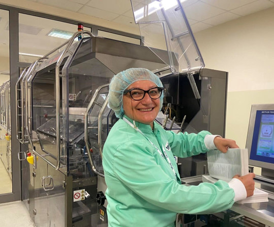 Yuliyana next to her packaging machine