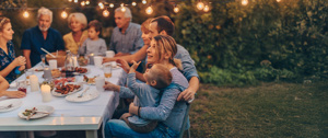 Family having a dinner in the yard under the lights