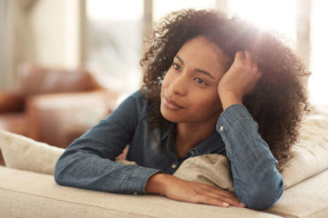 girl-laying-on-a-couch-thinking