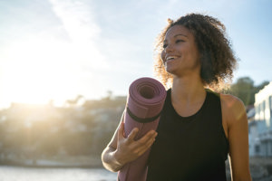 Happy woman reflecting on her health after exercising.