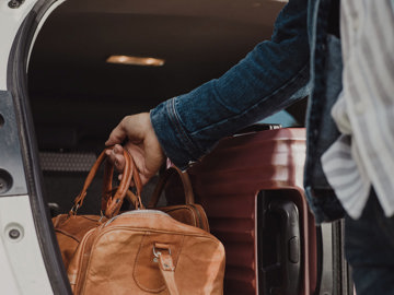 Male caregiver packing his bag for an upcoming holiday with his loved one