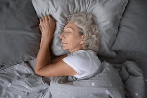 Mature woman with COPD comfortable and sleeping well in bed.