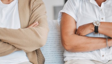 Two friends with arms folded offended as one rejected unsolicited advice about chronic illness