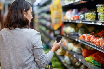 Woman planning meals in supermarket