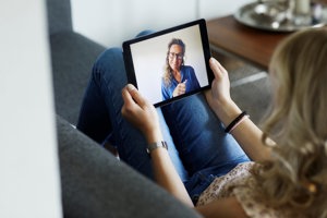 Woman with MS has an online therapy session with her counselor