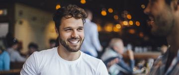 man smiling and drinking coffe